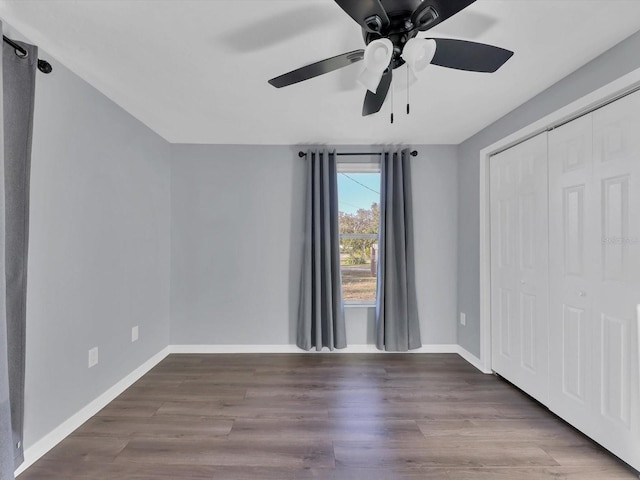 unfurnished bedroom with hardwood / wood-style floors, ceiling fan, and a closet