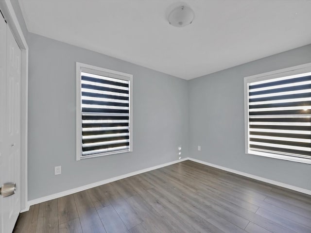 unfurnished room featuring hardwood / wood-style floors