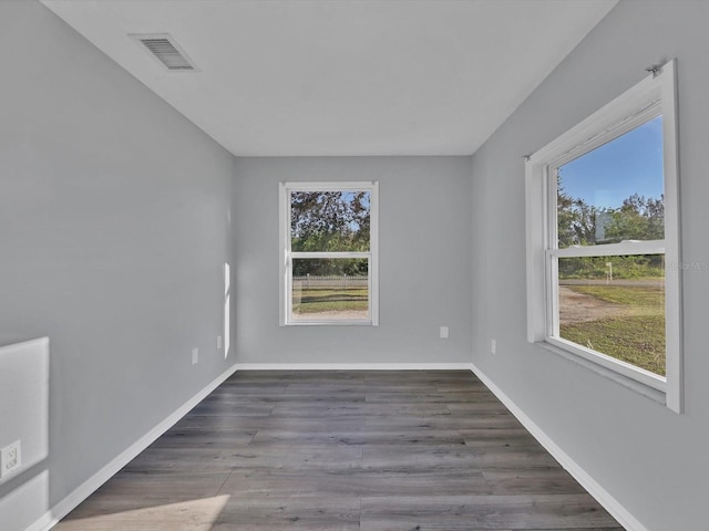 unfurnished room featuring dark wood-type flooring