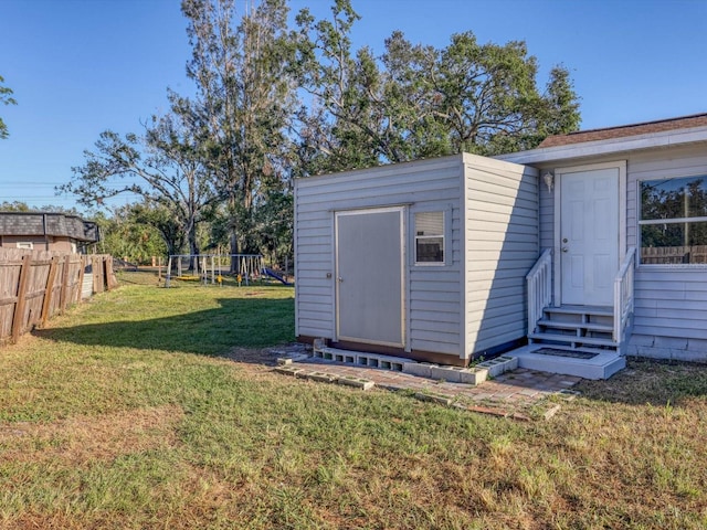 view of yard with a storage unit and a playground