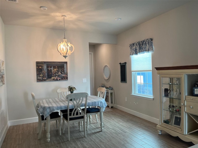 dining area with a chandelier and hardwood / wood-style flooring