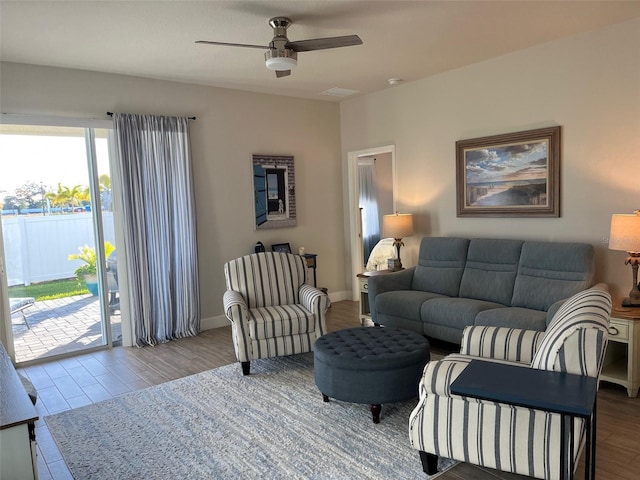 living room featuring ceiling fan and light wood-type flooring