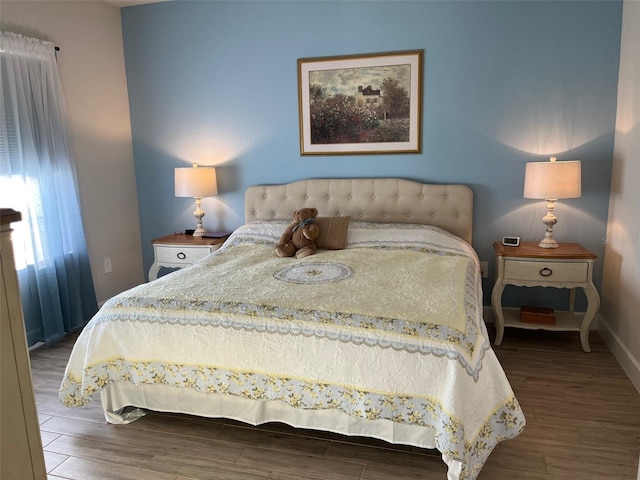 bedroom with hardwood / wood-style flooring