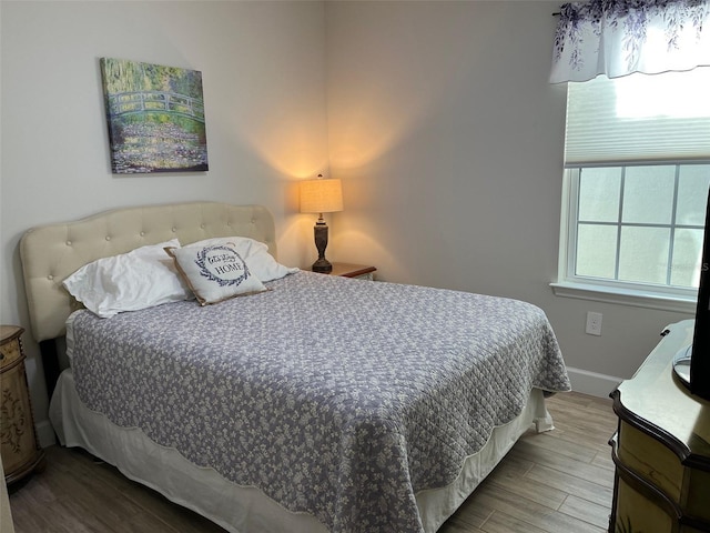 bedroom with hardwood / wood-style flooring