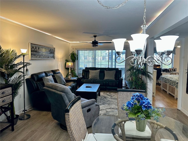 living room with hardwood / wood-style floors, ceiling fan, and crown molding