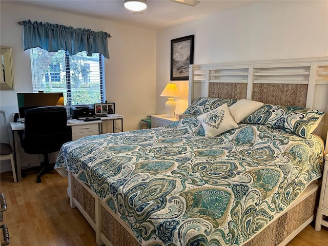 bedroom with ceiling fan and hardwood / wood-style flooring