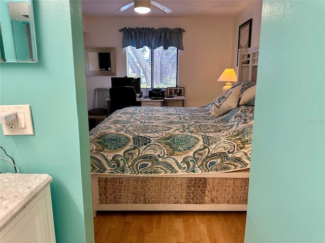 bedroom with ceiling fan and light wood-type flooring