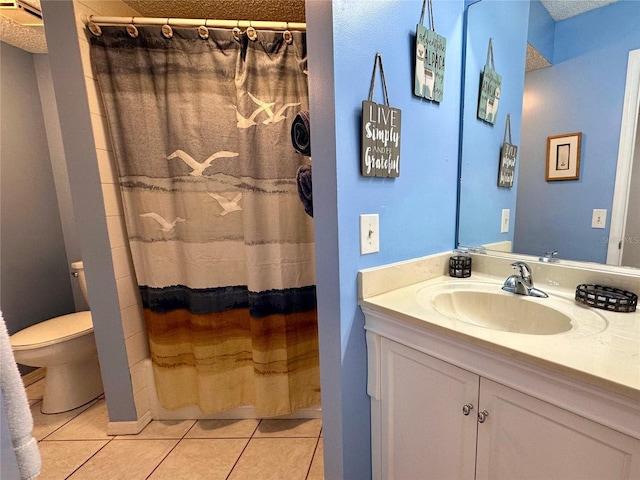 bathroom featuring tile patterned floors, vanity, curtained shower, and toilet