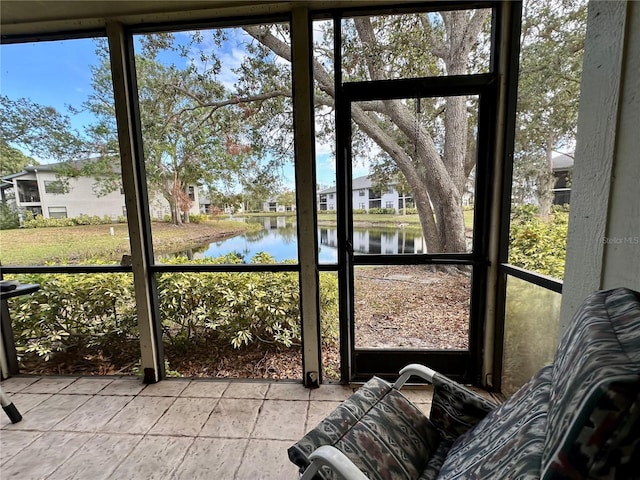 unfurnished sunroom featuring a water view