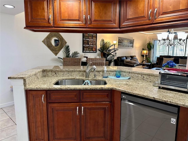 kitchen with light stone counters, stainless steel dishwasher, sink, light tile patterned floors, and a notable chandelier