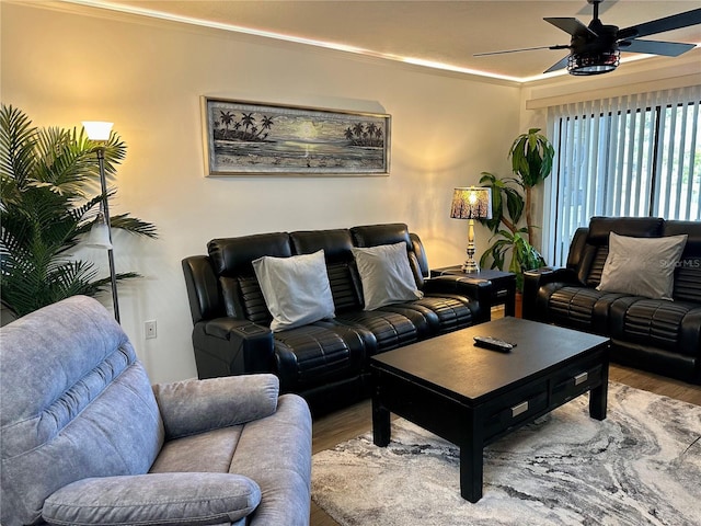 living room featuring ceiling fan, wood-type flooring, and ornamental molding