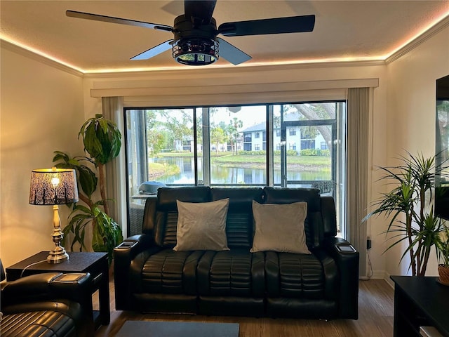 interior space with a wealth of natural light, ceiling fan, a water view, and wood-type flooring