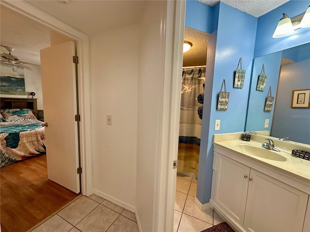 bathroom with vanity, a textured ceiling, and tile patterned floors