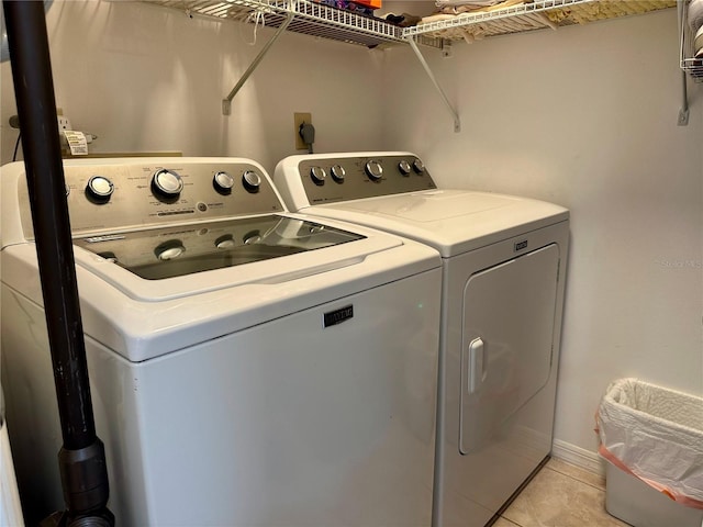 laundry area featuring light tile patterned floors and separate washer and dryer