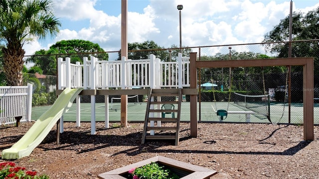 view of jungle gym featuring tennis court