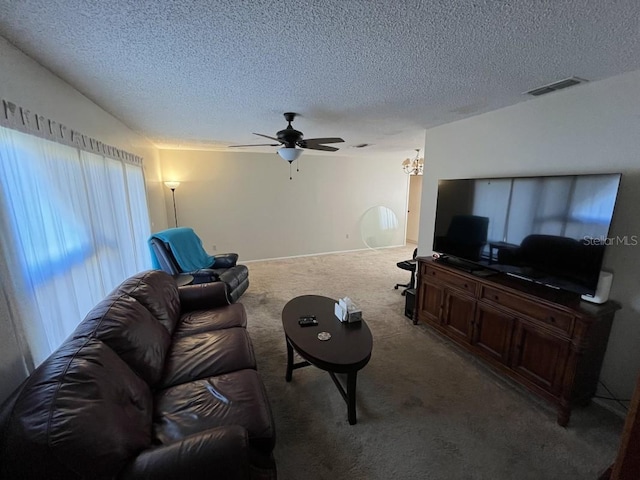 carpeted living room featuring a textured ceiling and ceiling fan