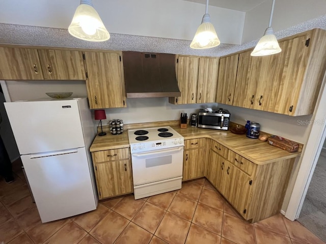 kitchen featuring pendant lighting, light tile patterned floors, white appliances, and range hood