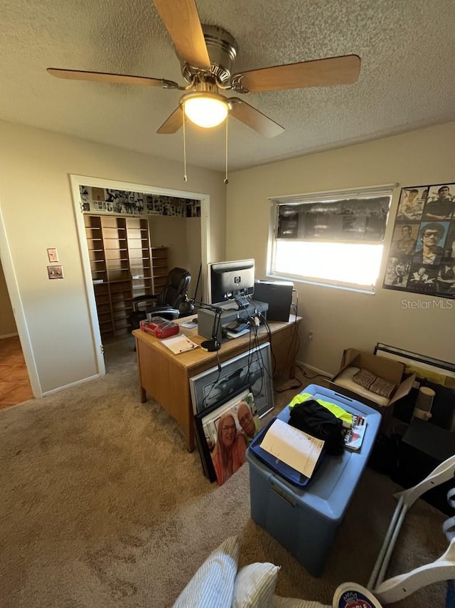 office space featuring a textured ceiling, carpet floors, and ceiling fan