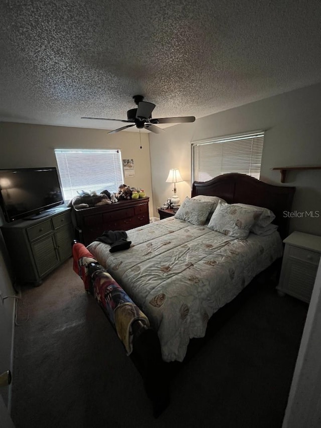 carpeted bedroom with ceiling fan and a textured ceiling