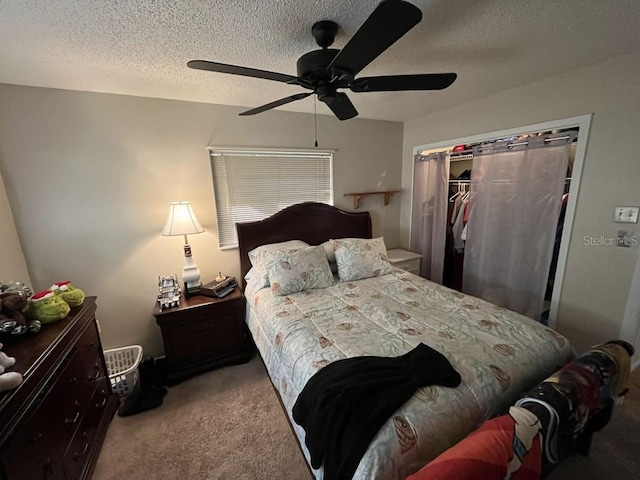 bedroom featuring carpet flooring, ceiling fan, a closet, and a textured ceiling