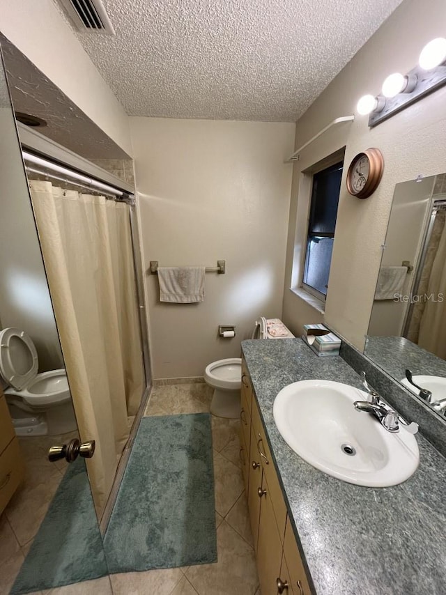 bathroom featuring tile patterned flooring, vanity, a textured ceiling, and a shower with shower curtain