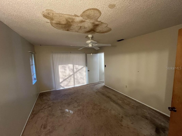 spare room with carpet flooring, a textured ceiling, and ceiling fan