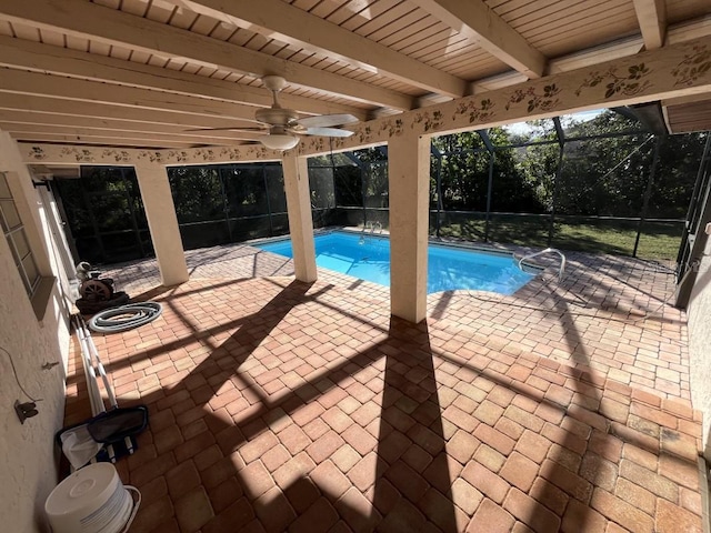 view of pool featuring a patio, ceiling fan, and a lanai