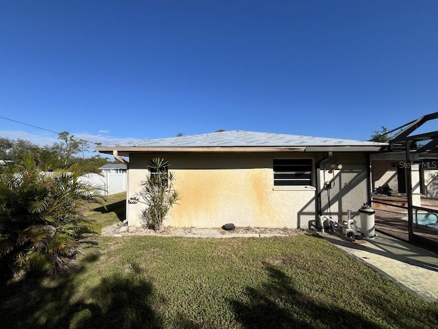 view of side of home featuring a lawn