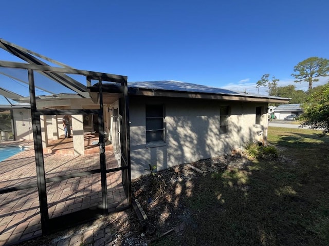 view of side of property with a patio