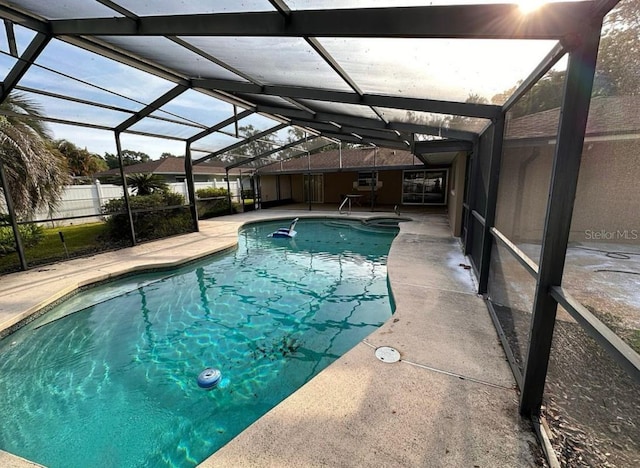 view of swimming pool with glass enclosure and a patio area