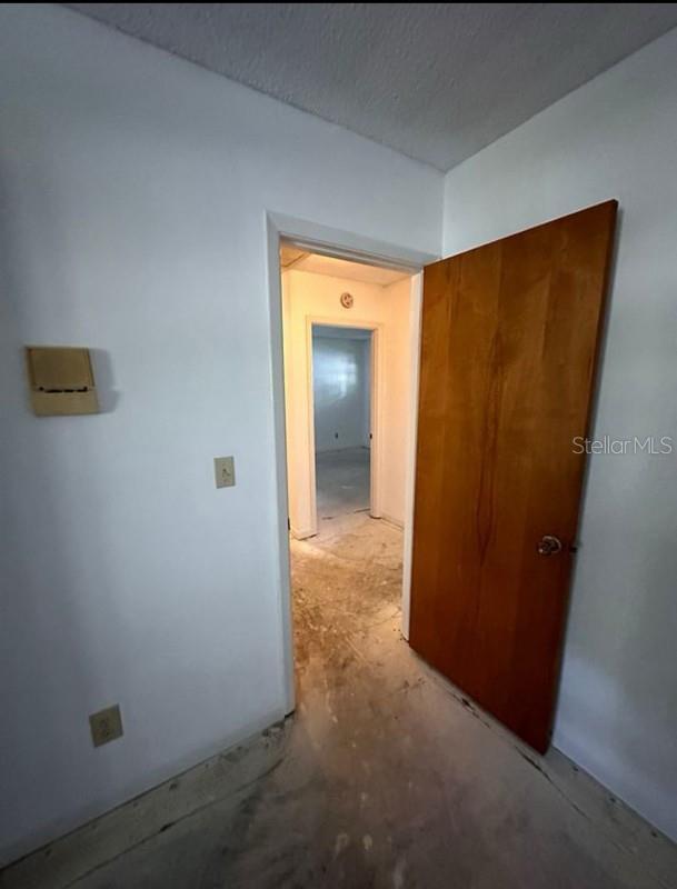 hallway with a textured ceiling