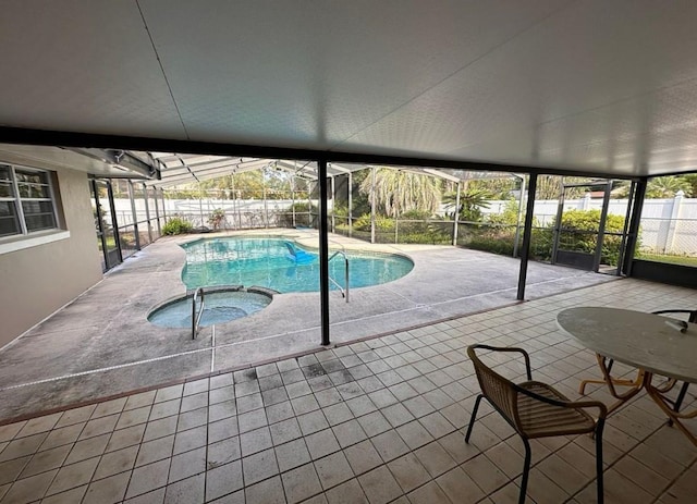 view of swimming pool featuring a lanai, an in ground hot tub, and a patio