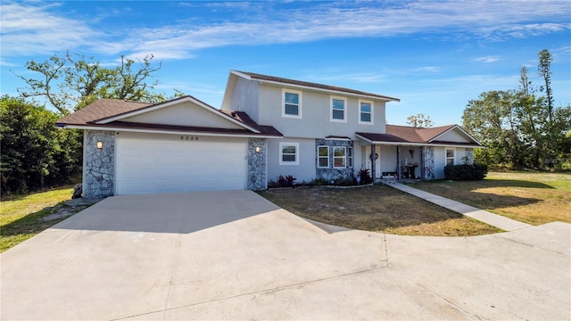 view of front of home featuring a front yard and a garage