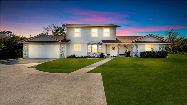 view of front property featuring a lawn and a garage