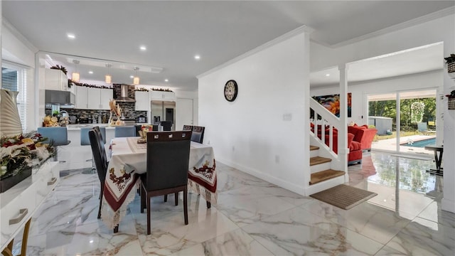 dining space featuring ornamental molding