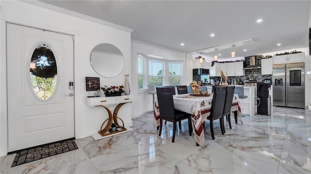 dining space with crown molding