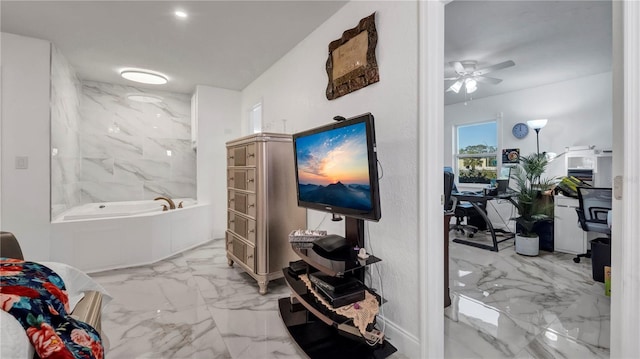 bathroom with ceiling fan and a tub