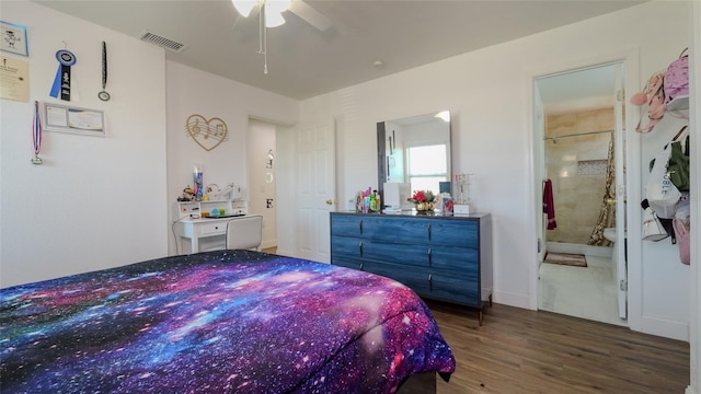 bedroom with hardwood / wood-style floors, connected bathroom, and ceiling fan