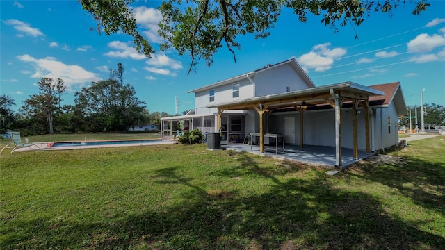 rear view of house with a yard, a patio, and central air condition unit