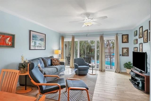 living room with light hardwood / wood-style floors, ceiling fan, and ornamental molding