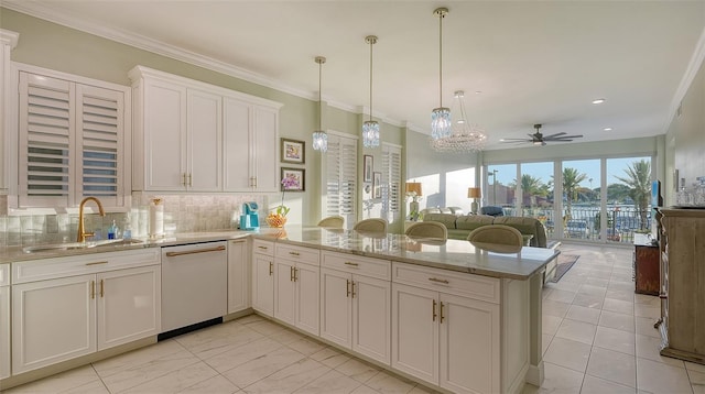 kitchen featuring pendant lighting, dishwasher, kitchen peninsula, and sink