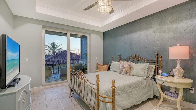 tiled bedroom with a tray ceiling, access to exterior, ceiling fan, and ornamental molding