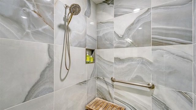 interior details with a tile shower