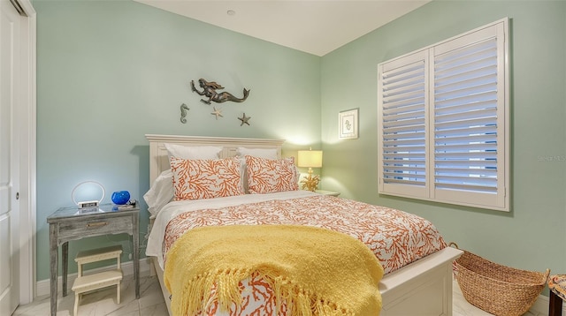 bedroom with light tile patterned floors and a closet