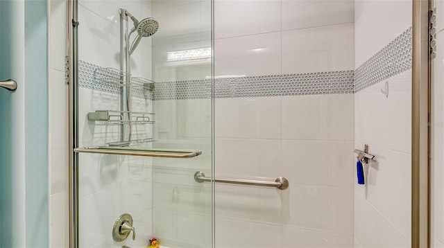 bathroom featuring a shower with door