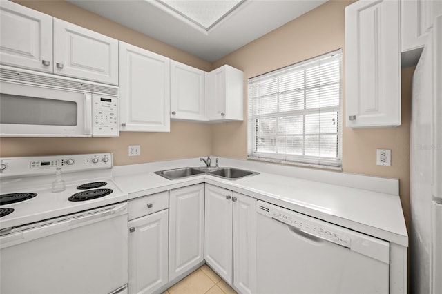 kitchen featuring white cabinets, light tile patterned floors, white appliances, and sink