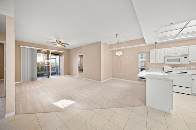 kitchen featuring range with electric cooktop, white cabinets, pendant lighting, and light colored carpet