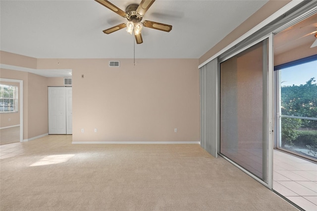 unfurnished room with ceiling fan and light carpet