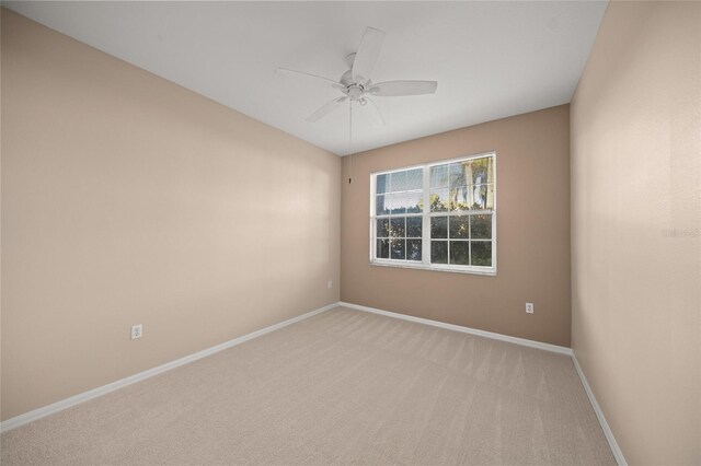 spare room featuring ceiling fan and light colored carpet