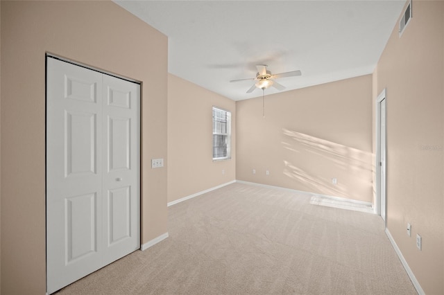 carpeted spare room with ceiling fan